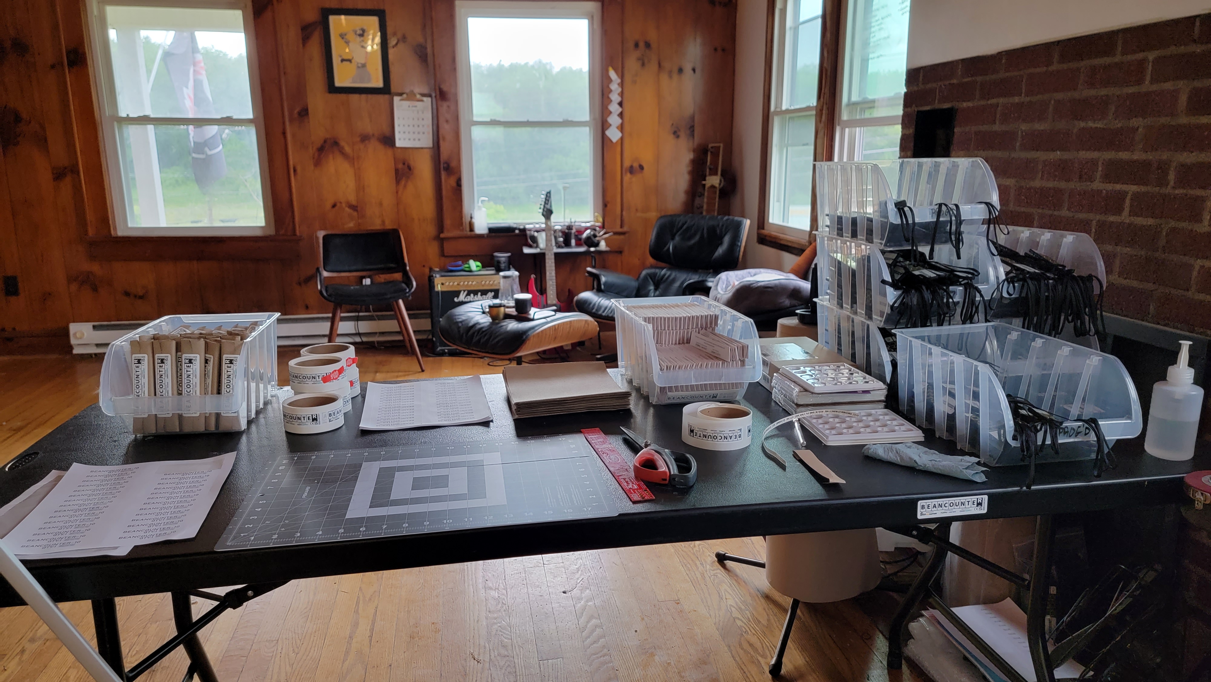 A folding table in my living room covered in assembled BeanCounter units and packaging