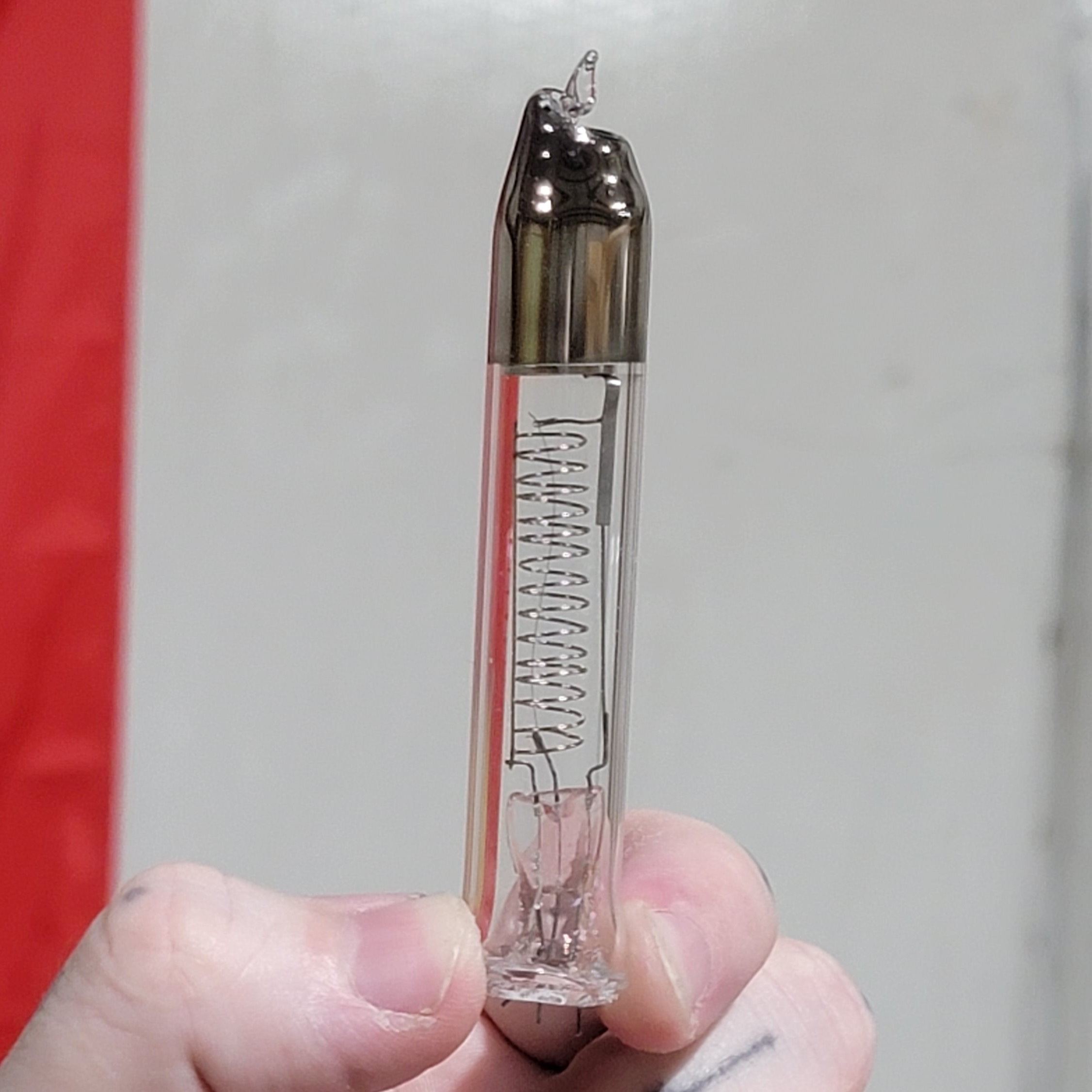 Close-up of the tube from the previous image with a silvery deposit on the inside top of the tube