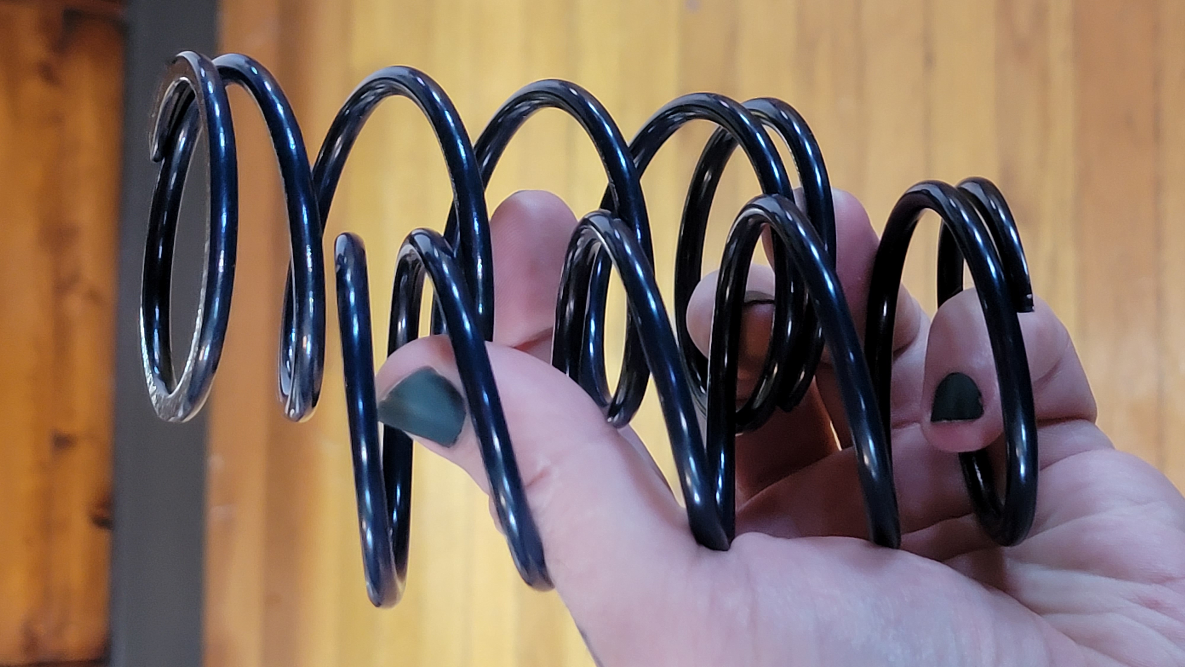 A pair of large coil springs with dark blue powder coat