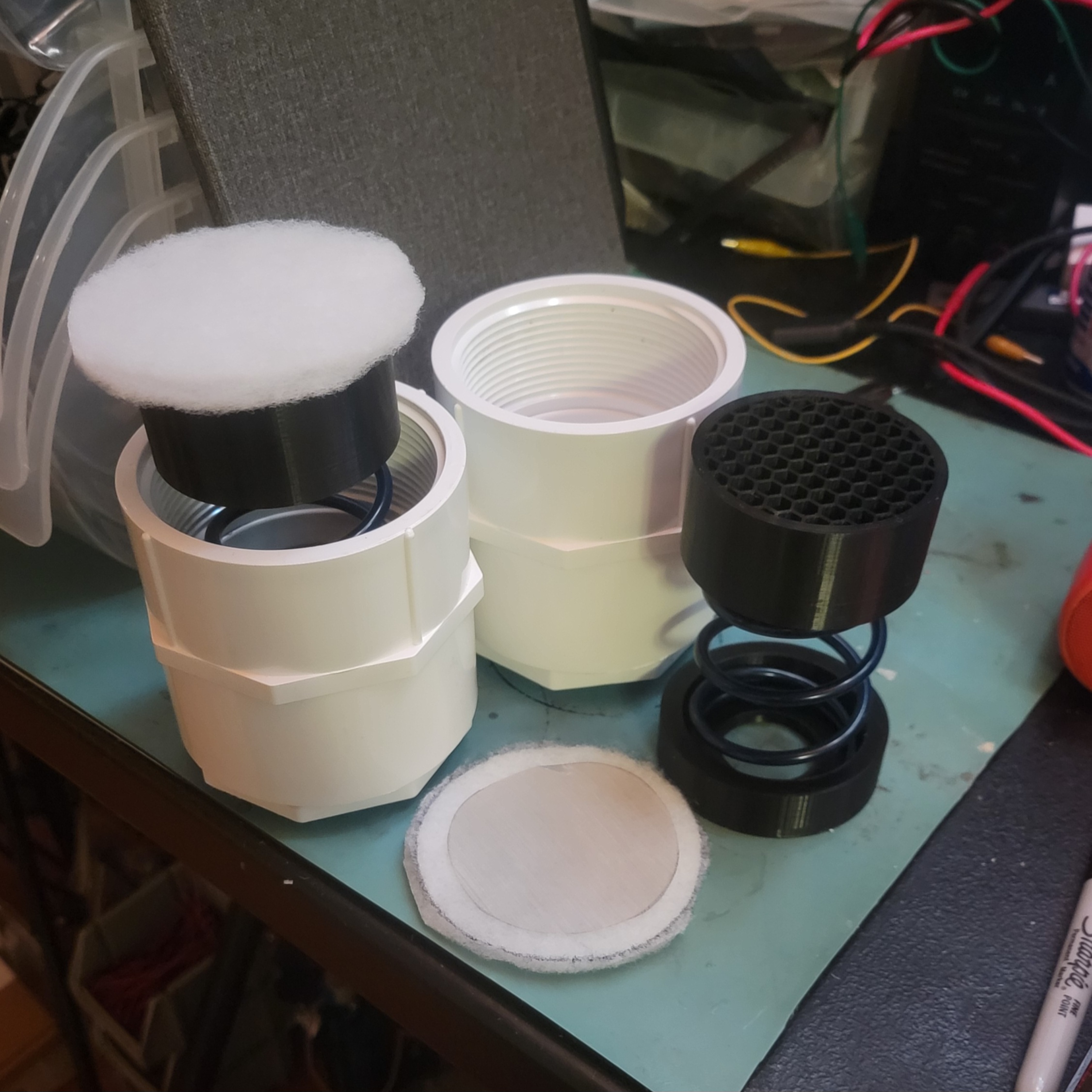 PVC end caps with pistons and springs inserted